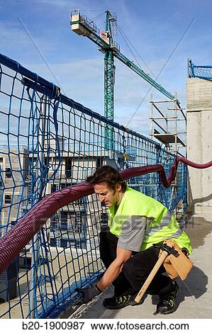 Mason placing security protection, Bricklayer with personal protective equipment, PPE, Apartment Building under construction, Donostia, San Sebastian, Gipuzkoa, Basque Country, Spain View Large Photo Image Stock Photo - Mason placing security protection, Bricklayer with personal protective equipment, PPE, Apartment Building under construction, Donostia, San Sebastian, Gipuzkoa, Basque Country, Spain. Fotosearch