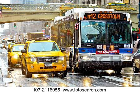 Mass Transit on Pershing Square, M42 MTA Crosstown Bus, outside Grand Central Terminal, morning rush hour during a snow and rain storm, Madison Avenue, Park Avenue, Midtown Manhattan, New York City, USA. View Large Photo Image Stock Photography - Mass Transit on Pershing Square, M42 MTA Crosstown Bus, outside Grand Central Terminal, morning rush hour during a snow and rain storm, Madison Avenue, Park Avenue, Midtown Manhattan, New York City, USA.. Fotosearch