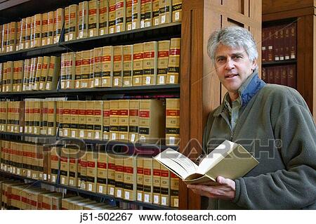 Massachusetts, Boston, Male alumnus in Harvard Law School library hold open legal book, interior with rows of books View Large Photo Image Stock Photo - Massachusetts, Boston, Male alumnus in Harvard Law School library hold open legal book, interior with rows of books. Fotosearch