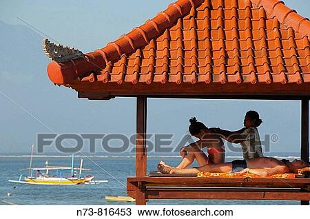 Stock Image - Massage by the beach of Sanur, Bali, Indonesia. Fotosearch