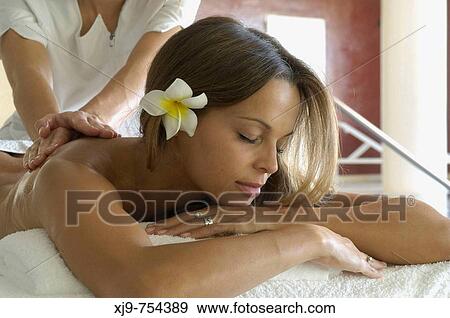 Stock Photo - Massage on back of girl lying.. Fotosearch