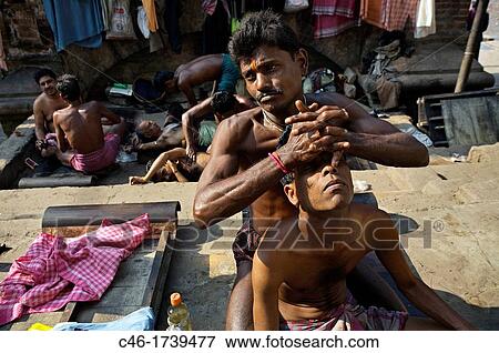 Masseurs give body massages to customers on a street, Kolkata, India, Ganges River. View Large Photo Image Stock Photo - Masseurs give body massages to customers on a street, Kolkata, India, Ganges River.. Fotosearch