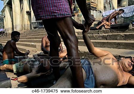 Masseurs give body massages to customers on a street, Kolkata, India, Ganges River. View Large Photo Image Stock Photography - Masseurs give body massages to customers on a street, Kolkata, India, Ganges River.. Fotosearch