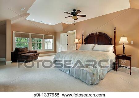Master Bedroom In Luxury Home With Tray Ceiling Stock