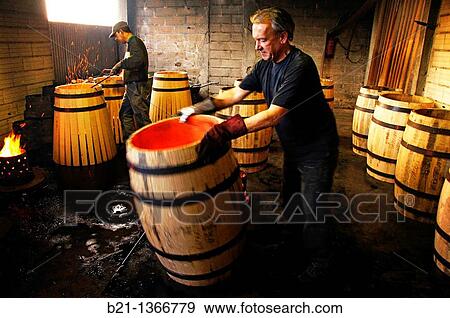 Stock Photo - Master cooper Francis M. working on burning of barrels at cooperage, at Marmande, Lot-et-Garonne, Aquitaine, France. Fotosearch