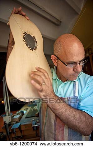 Master Luthier Guitar-Maker in his workshop in the process of making a classical Spanish guitar Barcelona SPAIN View Large Photo Image Picture - Master Luthier Guitar-Maker in his workshop in the process of making a classical Spanish guitar Barcelona SPAIN. Fotosearch