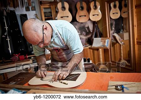 Master Luthier Guitar-Maker in his workshop in the process of making a classical Spanish guitar Barcelona SPAIN View Large Photo Image Stock Image - Master Luthier Guitar-Maker in his workshop in the process of making a classical Spanish guitar Barcelona SPAIN. Fotosearch