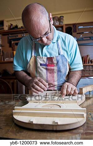 Master Luthier Guitar-Maker in his workshop in the process of making a classical Spanish guitar Barcelona SPAIN View Large Photo Image Stock Image - Master Luthier Guitar-Maker in his workshop in the process of making a classical Spanish guitar Barcelona SPAIN. Fotosearch
