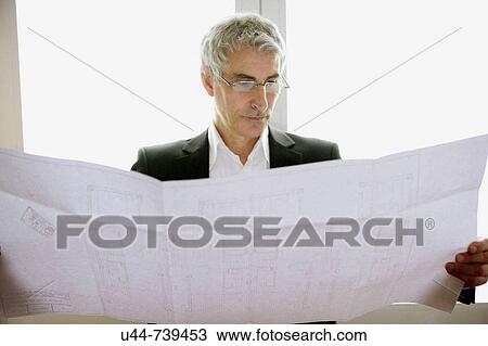 Matrure Architect looking at his plan View Large Photo Image Stock Image - Matrure Architect looking at his plan. Fotosearch