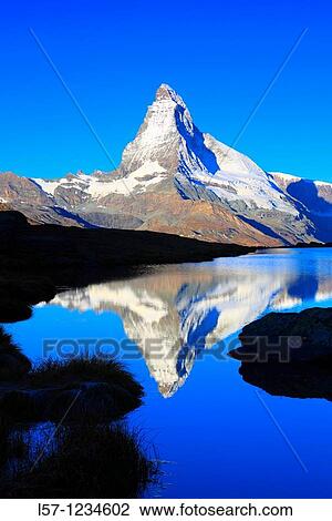 Matterhorn reflecting in mountain lake, Wallis, Schweiz View Large Photo Image Stock Image - Matterhorn reflecting in mountain lake, Wallis, Schweiz. Fotosearch
