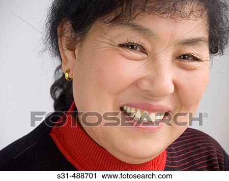 Mature Asian woman smiling to the camera. View Large Photo Image Stock Image - Mature Asian woman smiling to the camera.. Fotosearch