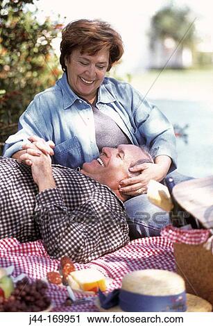 Stock Image - Mature couple having a picnic. Fotosearch