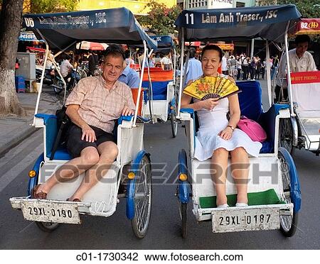 Mature couple of tourists in rickshaws touring the old town, Hanoi, Vietnam View Large Photo Image Stock Image - Mature couple of tourists in rickshaws touring the old town, Hanoi, Vietnam. Fotosearch