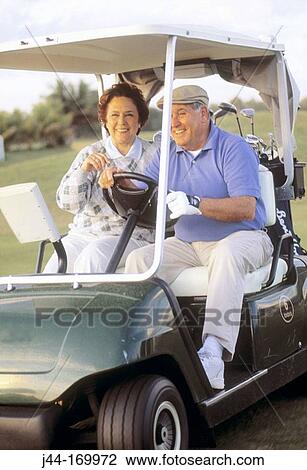 Mature couple on a golf cart View Large Photo Image Stock Image - Mature couple on a golf cart. Fotosearch