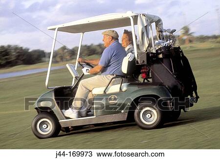 Mature couple riding a golf cart View Large Photo Image Stock Image - Mature couple riding a golf cart. Fotosearch