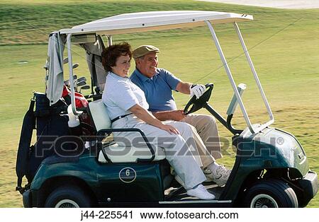 Mature couple riding a golf cart View Large Photo Image Stock Image - Mature couple riding a golf cart. Fotosearch