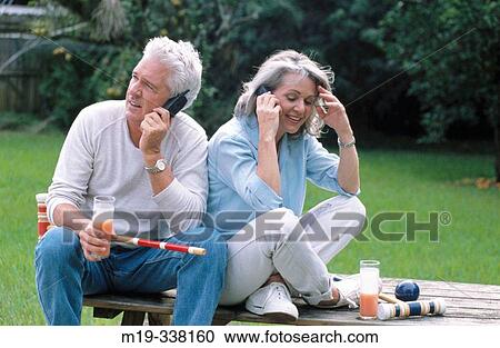 Mature couple using cell phones View Large Photo Image Stock Image - Mature couple using cell phones. Fotosearch