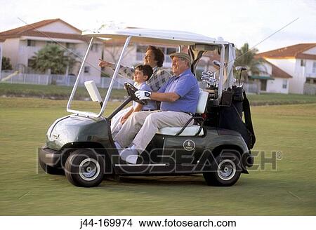 Mature couple with grandchild in a golf cart View Large Photo Image Picture - Mature couple with grandchild in a golf cart. Fotosearch