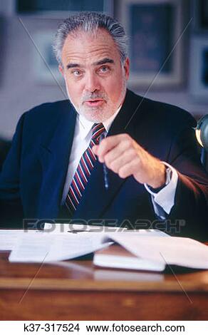 Mature executive businessman at desk View Large Photo Image Picture - Mature executive businessman at desk. Fotosearch