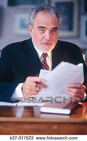 Mature executive businessman at desk View Large Photo Image Stock Image - Mature executive businessman at desk. Fotosearch