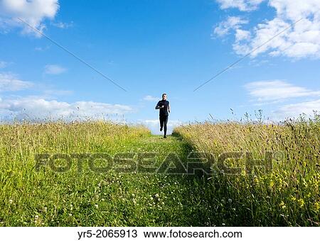 Mature male running through wildflower meadow at Cowpen Bewley Woodland Park, Billingham, Cleveland, England, United Kingdom View Large Photo Image Stock Image - Mature male running through wildflower meadow at Cowpen Bewley Woodland Park, Billingham, Cleveland, England, United Kingdom. Fotosearch