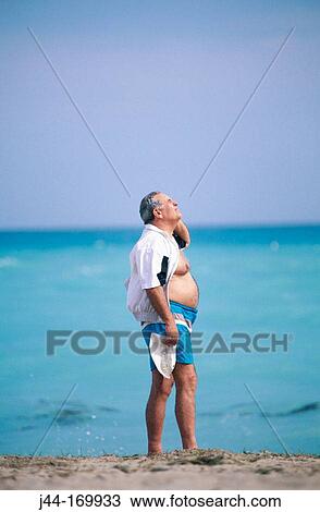 Mature man at the beach View Large Photo Image Stock Image - Mature man at the beach. Fotosearch