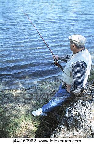 Mature man fishing in a lake, Florida, USA View Large Photo Image Stock Image - Mature man fishing in a lake, Florida, USA. Fotosearch