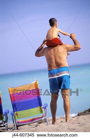 Mature man holding grandchild on his shoulder View Large Photo Image Stock Photography - Mature man holding grandchild on his shoulder. Fotosearch