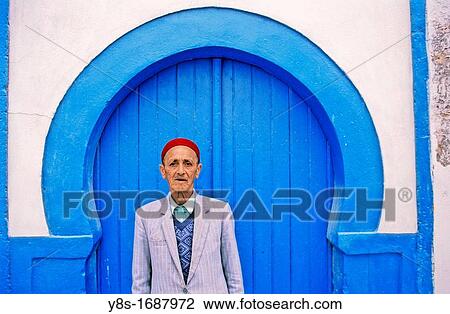 Mature Man in front of blue door View Large Photo Image Stock Image - Mature Man in front of blue door. Fotosearch