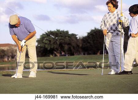 Mature man playing golf with wife and grandchild View Large Photo Image Stock Image - Mature man playing golf with wife and grandchild. Fotosearch