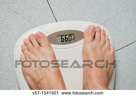 Mature man weighing himself View Large Photo Image Stock Image - Mature man weighing himself. Fotosearch
