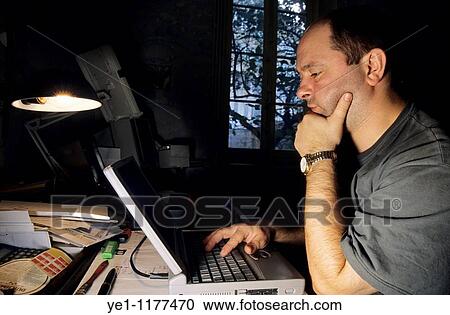 Mature man working at home on his laptop computer. View Large Photo Image Stock Image - Mature man working at home on his laptop computer.. Fotosearch