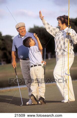 Stock Photo - Mature woman and mature man celebrating while playing golf. Fotosearch