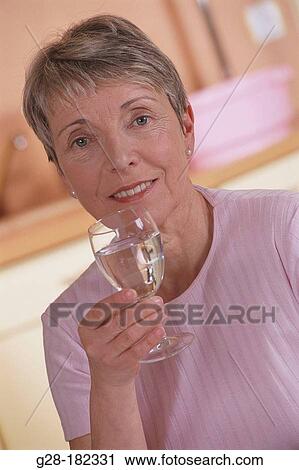 Mature woman drinking water View Large Photo Image Stock Image - Mature woman drinking water. Fotosearch