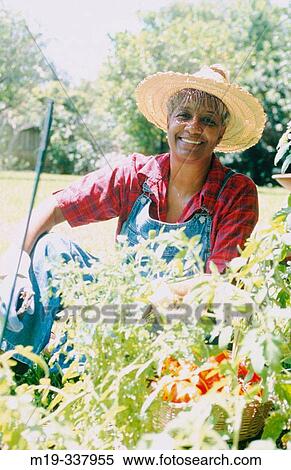 Stock Photography - mature woman in in her garden. Fotosearch