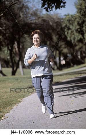 Mature woman jogging outdoor, Florida View Large Photo Image Stock Photograph - Mature woman jogging outdoor, Florida. Fotosearch