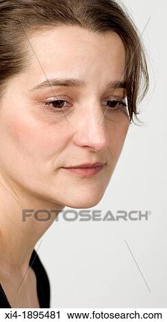 mature woman looking down with sorrow expression View Large Photo Image Stock Image - mature woman looking down with sorrow expression. Fotosearch