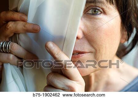 Stock Image - mature woman looking relaxed and cheerful. Fotosearch