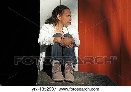 Stock Photo - Mature woman on covered bridge. Fotosearch