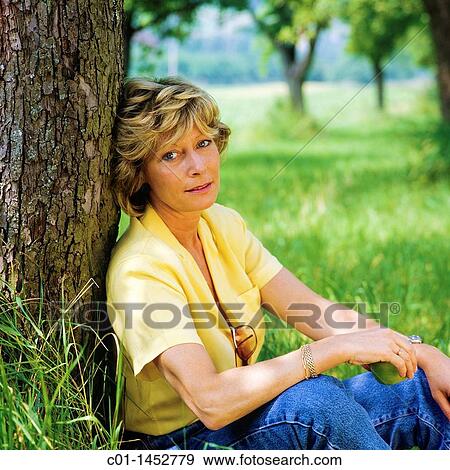 Mature woman portrait in garden View Large Photo Image Stock Photo - Mature woman portrait in garden. Fotosearch
