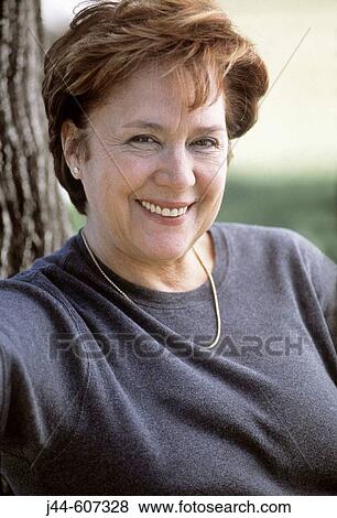 Mature woman smiling outdoors View Large Photo Image Stock Photo - Mature woman smiling outdoors. Fotosearch