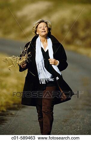 Mature woman strolling View Large Photo Image Stock Image - Mature woman strolling. Fotosearch