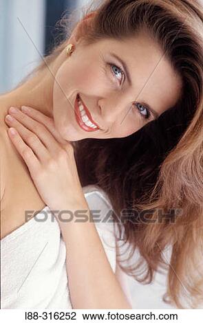 Stock Image - Mature woman using white towel after shower. Fotosearch