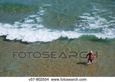 Mature woman wading in the water, El Sardinero beach. Santander, Cantabria province, Spain. View Large Photo Image Picture - Mature woman wading in the water, El Sardinero beach. Santander, Cantabria province, Spain.. Fotosearch