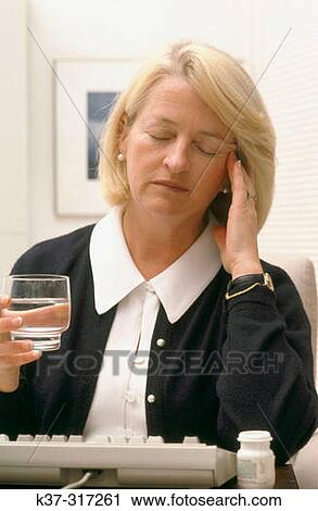 Mature woman with glass of water, suffering from headache View Large Photo Image Stock Image - Mature woman with glass of water, suffering from headache. Fotosearch