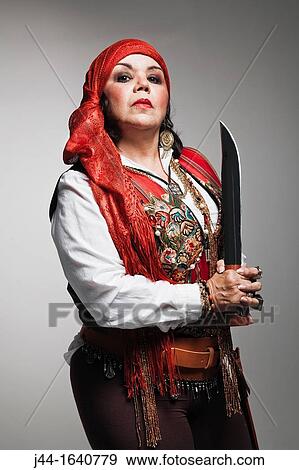 Mature woman with pirate costume holding a machete View Large Photo Image Stock Photo - Mature woman with pirate costume holding a machete. Fotosearch