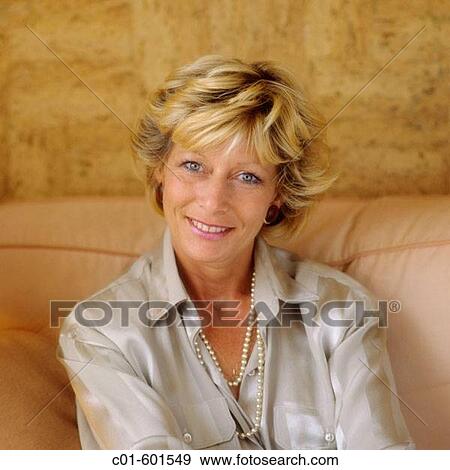 Mature woman's portrait on sofa View Large Photo Image Stock Photo - Mature woman's portrait on sofa. Fotosearch