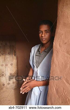Stock Image - Mauritania, Tichitt oasis, young at the door. Fotosearch