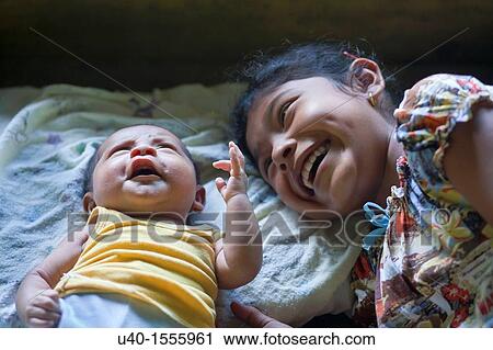 Mayan girl with baby brother View Large Photo Image Stock Image - Mayan girl with baby brother. Fotosearch