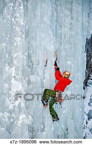 Stock Photograph - McLean Worsham ice climbing Genesis which is rated WI-4 and located in Hyalite Canyon in the Gallatin Mountains near the city of Bozeman in southern Montana. Fotosearch